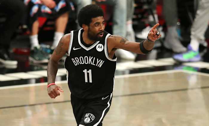 Brooklyn Nets point guard Kyrie Irving (11) reacts after making a basket against the Milwaukee Bucks during the second quarter of game one in the Eastern Conference semifinals of the 2021 NBA Playoffs at Barclays Center.